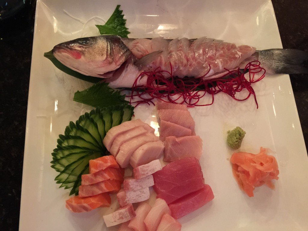 Sashimi patter featuring whole branzino with a ponzu-based sauce