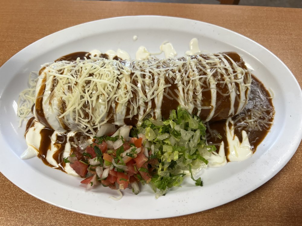 Wet burrito with red sauce and sour cream